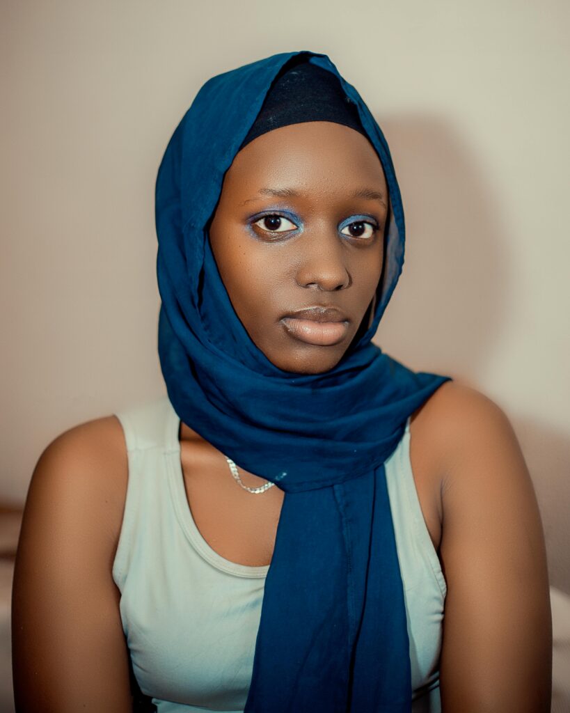 A stunning portrait of a woman wearing a blue hijab, embodying grace and cultural heritage.