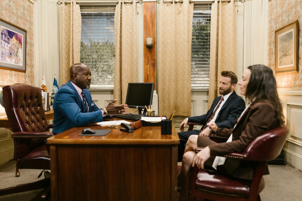 Lawyers discussing with a client in a professional office environment. Business meeting concept.